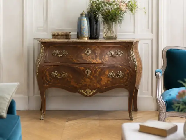 Commode ancienne à façade galbée et pieds cambrés, ornée de bronzes dorés en forme de coquilles et de feuillages